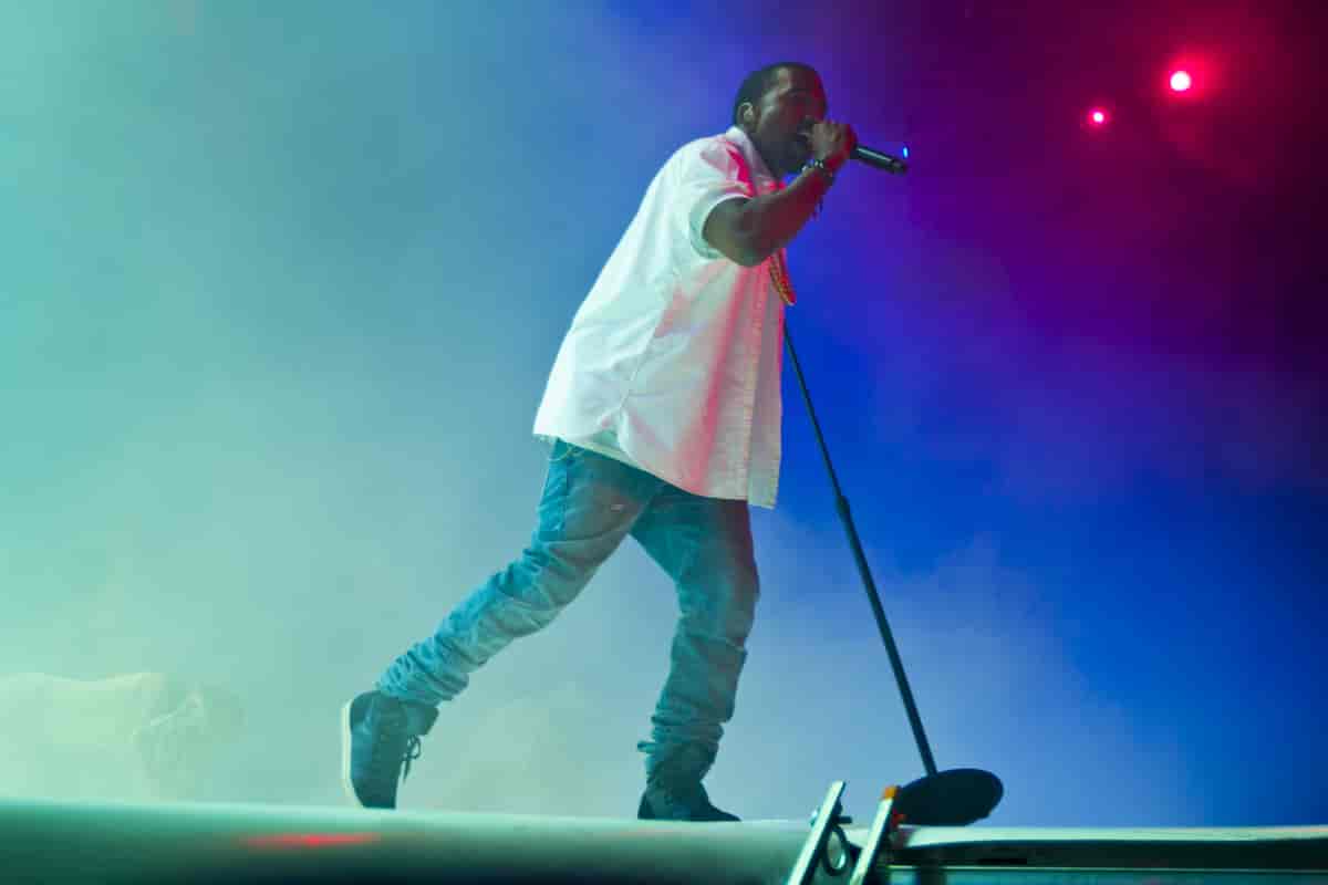 Kanye holding microphone on stage