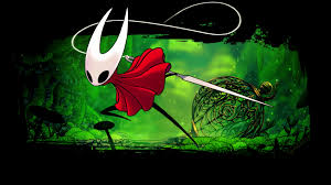 Black stick-figure like character with a red cloak and white mask in front of a green, lush background